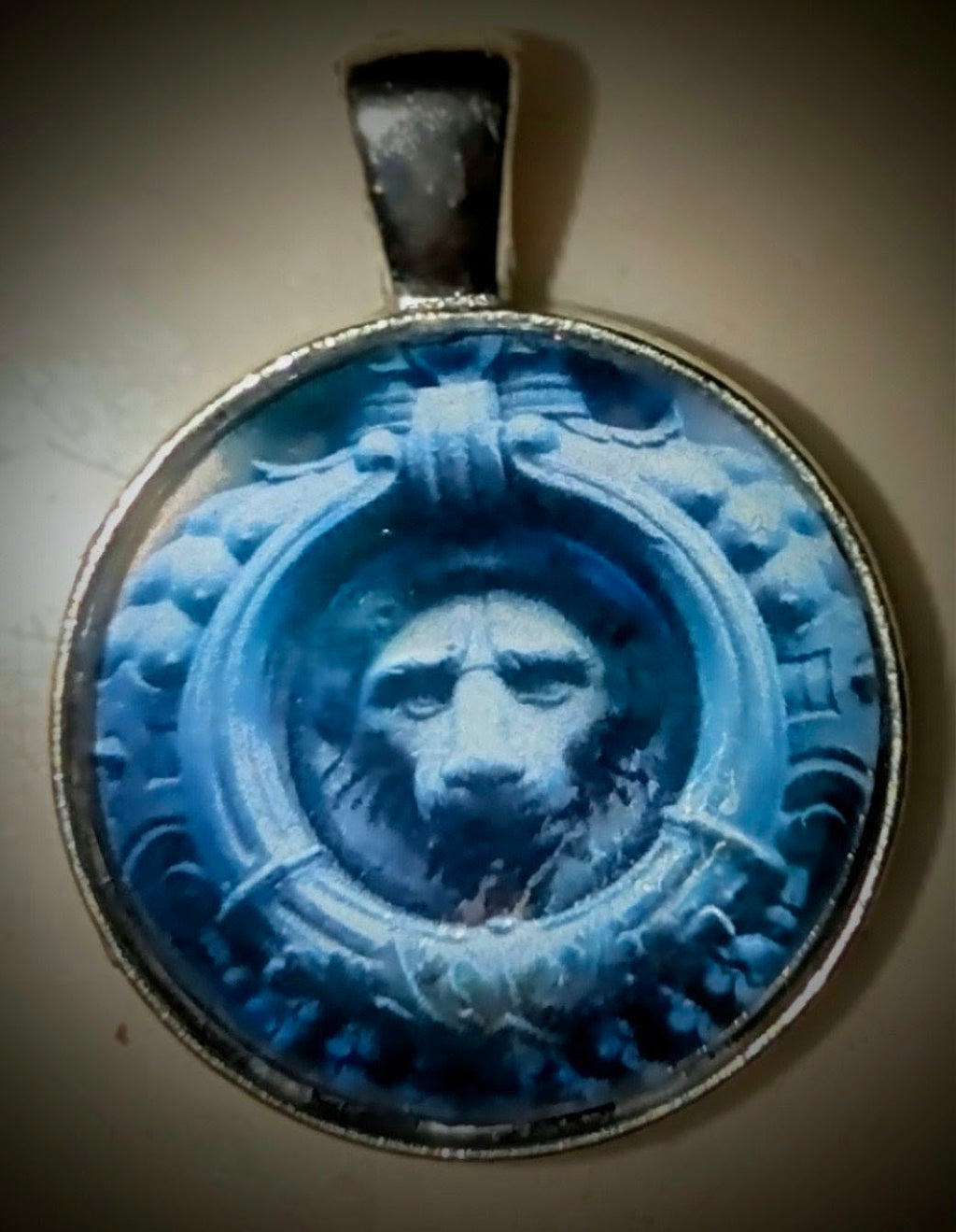 Macro photography pendant of the historic Lion of Firenze (Marzocco), capturing the weathered texture of Florentine stone in a decorative stainless steel round frame.